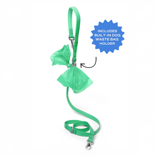 Green dog leash with built-in waste bag holder and green poop bags attached, shown on white background